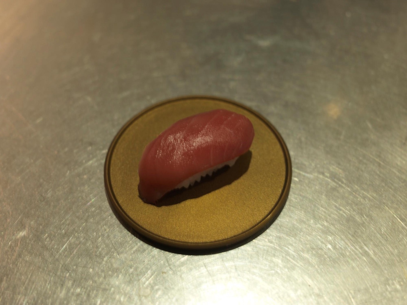 Sushi shot under light with poor color rendering. Doesn’t look very appetizing.